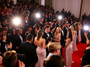 Celebrități pe covorul roșu la un eveniment exclusivist.